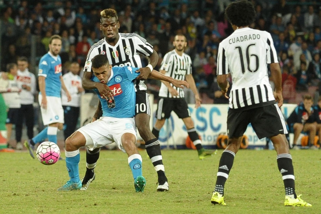 Juventus Paul Pogba battles for a ball with Napoli's Allan