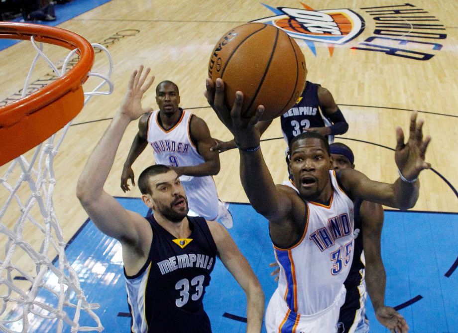 Oklahoma City Thunder forward Kevin Durant shoots in front of Memphis Grizzlies center Marc Gasol during the first quarter of an NBA basketball game in Oklahoma City. Durant has been cleared to play with