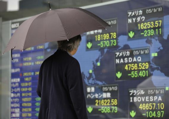 A man looks at an electronic stock indicator