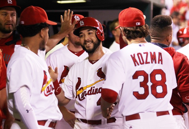 St. Louis Cardinals Tony Cruz is all smiles in the dugout after scoring the go-ahead run on a fly ball by Tommy Pham in the seventh inning against the Cincinnati Reds at Busch Stadium in St. Louis