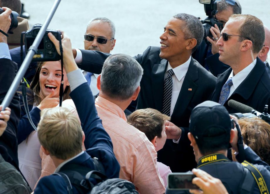 President Barack Obama greets guests after arriving at John F. Kennedy International Airport in New York Sunday Sept. 27 2015. Obama and the leaders of some of America's most stalwart allies will address the 2015 Sustainable Development Summit on its