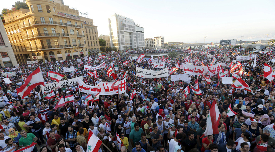 People carry Lebanese national flags and chant slogans as they take part in an anti-government protest at Martyrs&#039 Square in downtown Beirut Leban