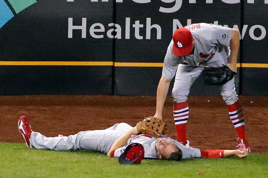 St. Louis Cardinals center fielder Peter Bourjos checks teammate left fielder Stephen Piscotty after the two collided while catching a fly ball by Pittsburgh Pirates Josh Harrison in the seventh inning of a baseball game in Pittsburgh Monday Sept