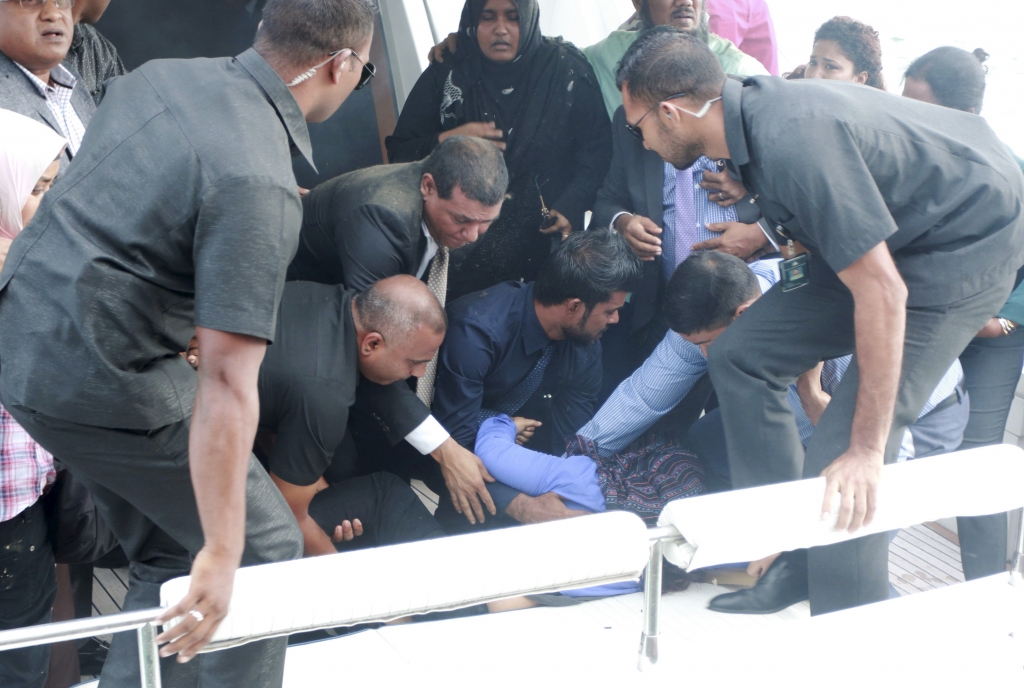 Officials carry an injured woman off the speed boat of Maldives President Abdulla Yameen after an explosion onboard in Male Maldives