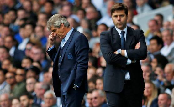 Manchester City manager Manuel Pellegrini looks dejected as Tottenham manager Mauricio Pochettino looks