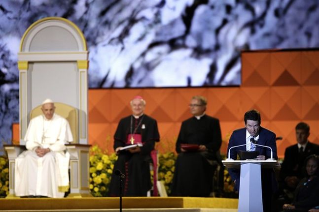 Actor Mark Wahlberg speaks as Pope Francis is seated nearby during the Festival of Families Saturday Sept. 26 2015 in Philadelphia