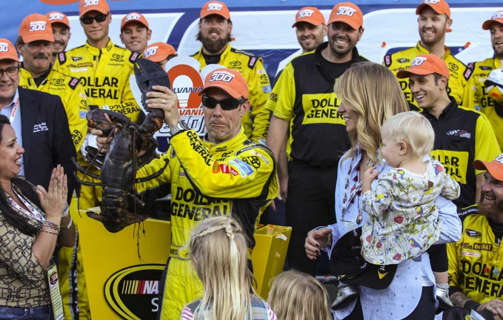 Matt Kenseth holds a lobster in Victory Lane after winning the NASCAR Sprint Cup series auto race at New Hampshire Motor Speedway in Loudon N.H