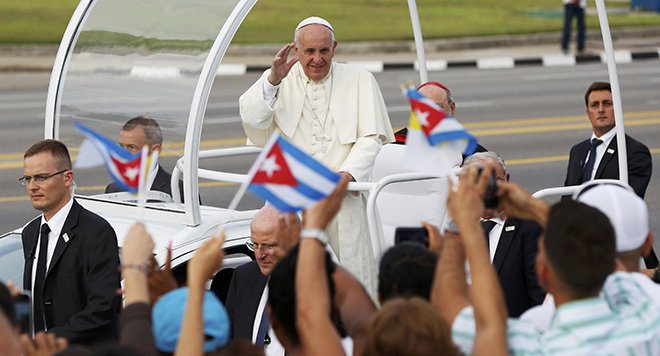 Messenger of peace Pope Francis waves to the crowd as he arrives to celebrate Mass in Revolution Square in Havana on September 20