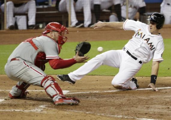 Miami Marlins J.T. Realmuto slides as Philadelphia Phillies