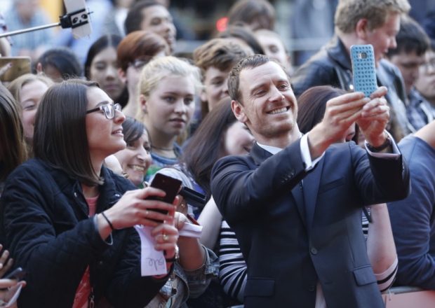 Actor Michael Fassbender seen taking selfies with fans plays Macbeth who is portrayed as a battle-weary soldier who is suffering post-traumatic stress disorder