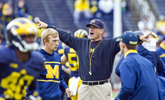 Jim Harbaugh directs his players during warmups before an NCAA college football game against UNLV in Ann Arbor Mich. Saturday Sept. 19 2015