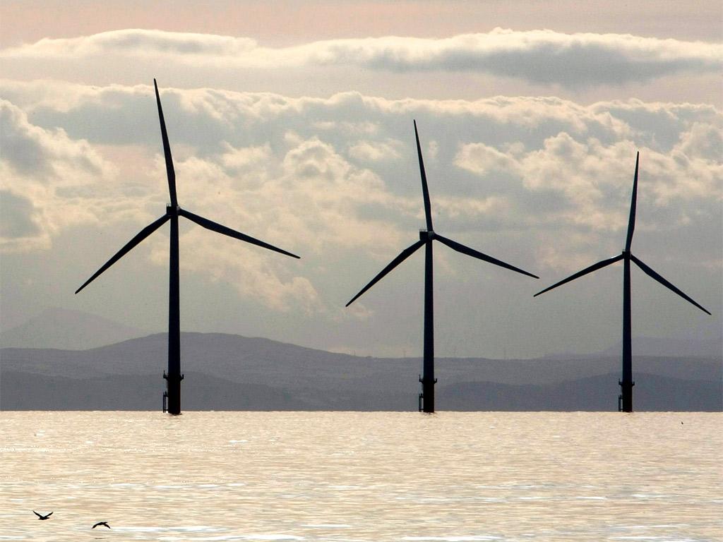 Turbines of the Burbo Bank off shore wind farm adorn the skyline in the mouth of the River Mersey