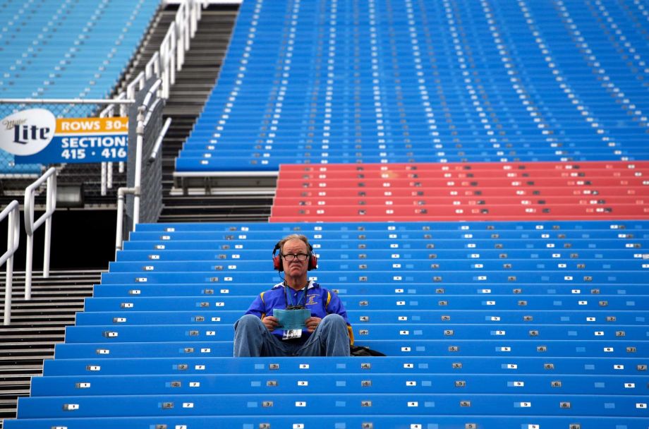 A race fan looks to the track before the NASCAR Camping World Truck Series auto race at Chicagoland Speedway Saturday Sept. 19 2015 in Joliet Ill