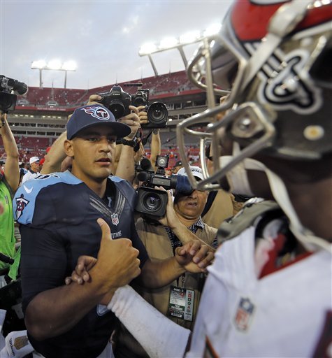 Tennessee Titans quarterback Marcus Mariota left shakes hands with Tampa Bay Buccaneers quarterback Jameis Winston after the Titans defeated the Buccaneers 42-14 during an NFL football game Sunday Sept. 13 2015 in Tampa Fla