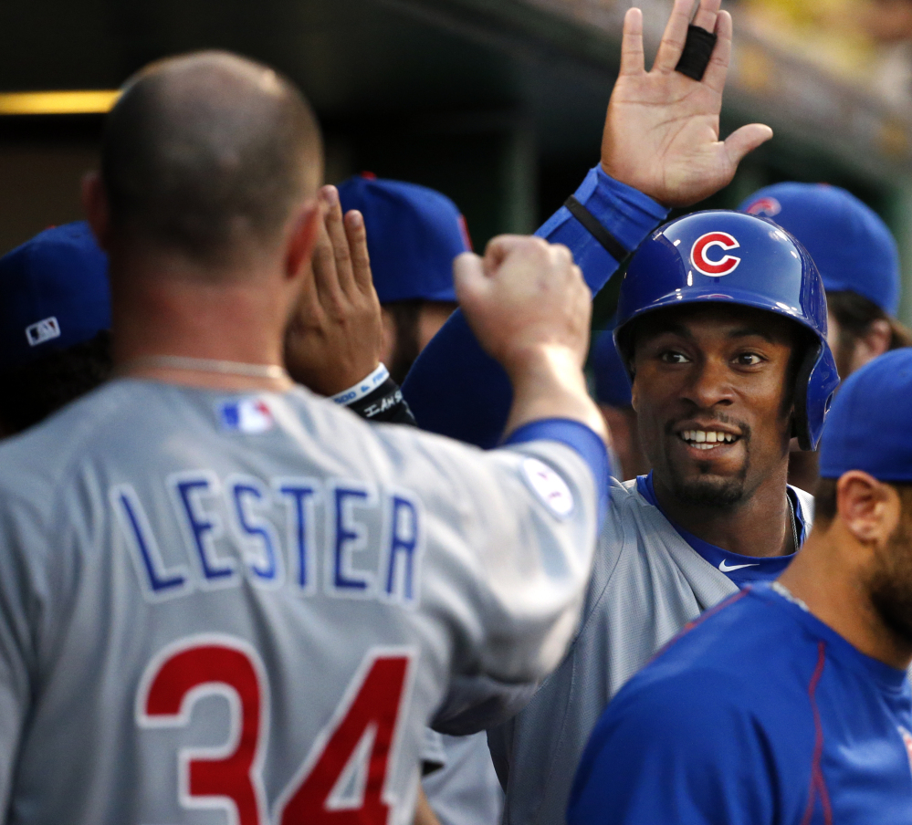 Austin Jackson second from right celebrates with Jon Lester in the second game of Tuesday’s doubleheader. The Cubs and Pirates split