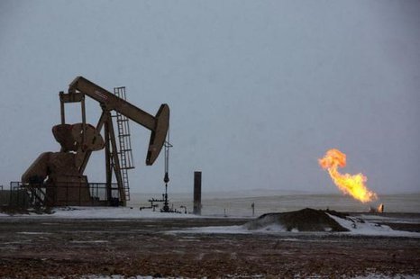 Natural gas flares are seen at an oil pump site outside of Williston North Dakota