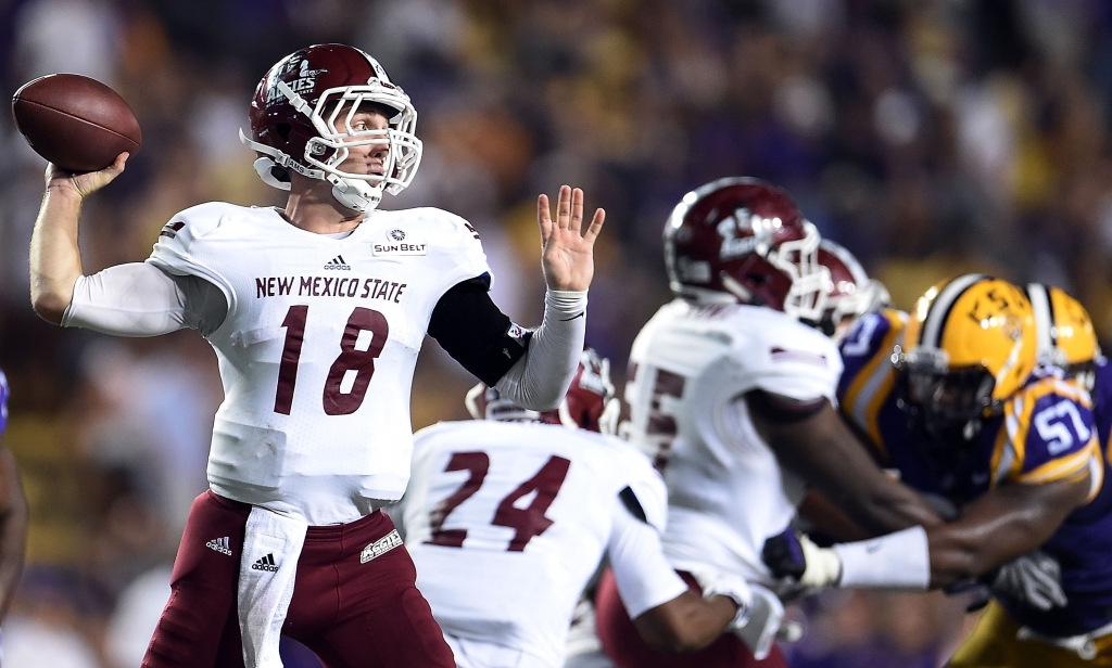 Tyler Rogers #18 of the New Mexico State Aggies drops back to pass against the LSU Tigers during the first quarter of a game at Tiger Stadium