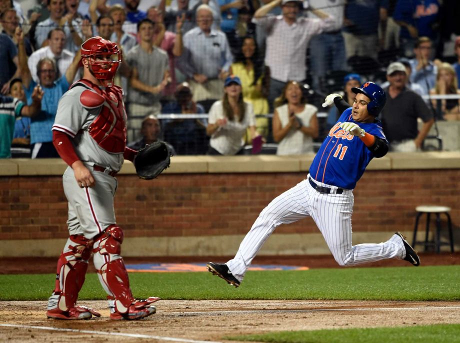 New York Mets Ruben Tejada slides into home plate past Philadelphia Phillies catcher Cameron Rupp for an inside the park two-run home run in the second inning of a baseball game on Wednesday Sept. 2 2015 in New York