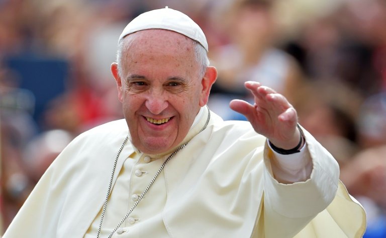 Pope Francis waves to faithful upon his arrival on St. Peter's square at the Vatican to lead his weekly general audience