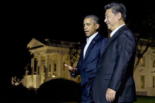 U.S. President Barack Obama and Chinese President Xi Jinping right walk on the North Lawn of the White House in Washington as they head for a private dinner at the Blair House across the street from the Wh