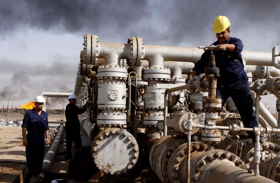 Iraqi laborers work at the Rumaila oil refinery in Zubair near the city of Basra Iraq. Across a Mideast fueled by oil production low global prices have some countries running on empty and scrambling to cover shor