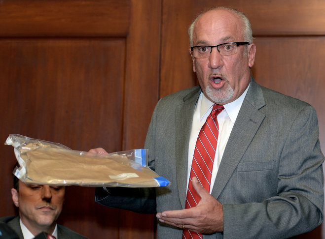 Thomas J. Eoannou a lawyer for a woman alleging she was sexually assaulted by Chicago Blackhawks forward Patrick Kane holds up what he says is an empty evidence bag that was improperly left in the doorway of the woman's mother's home during a news conf