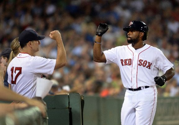 Jackie Bradley Jr. #25 of the Boston Red Sox slaps high fives after scoring a run in the seventh inning against the New York Yankees at Fenway Park