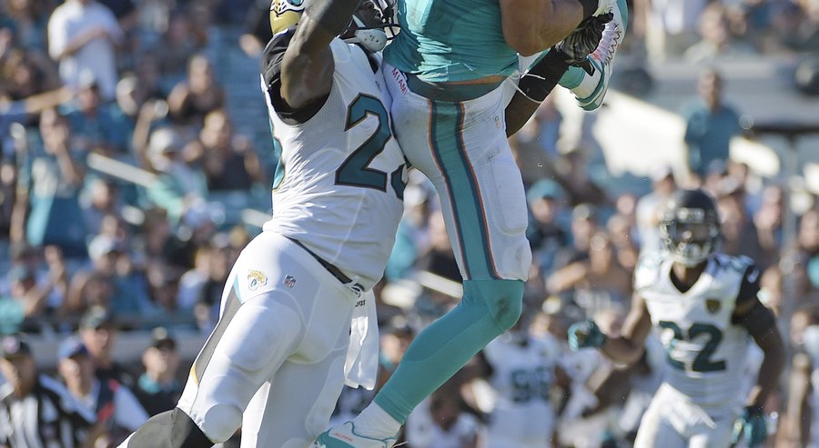 Miami Dolphins tight end Jordan Cameron makes the catch against Jacksonville Jaguars James Sample  during the first half of an NFL football game Sunday Sept. 20 2015 in Jacksonville Fla