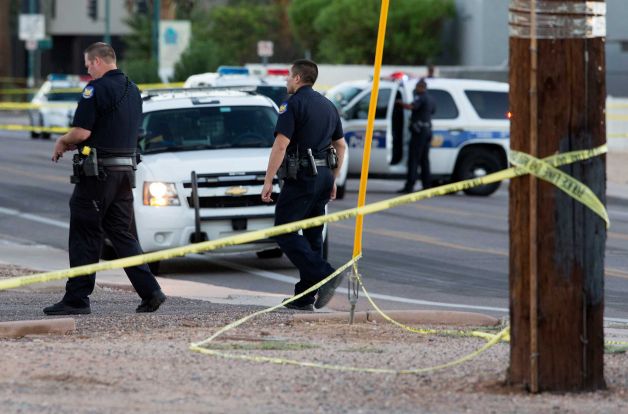 Phoenix police officers arrive at the scene where a Phoenix police officer was shot early Wednesday Sept. 16 2015 in Phoenix Ariz. Sgt. Jonathan Howard says the officer reported being shot while making a traffic stop of a Ford Thunderbird sedan carryi