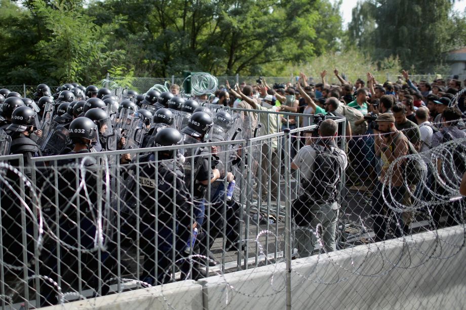 Hungarian police use pepper spray water cannons and tear gas to stop refugees at the Horgos border post. Some refugees hurled rocks at the police