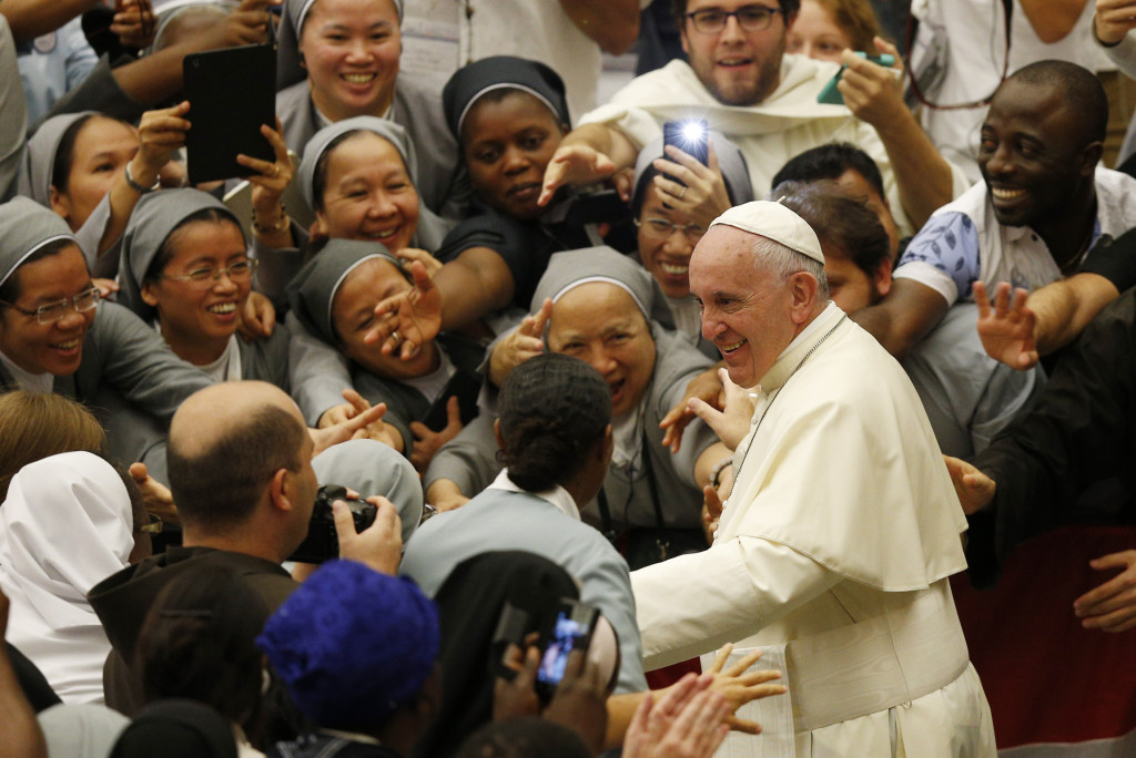 Pope Francis leaves an audience with religious from around the world in Paul VI hall at the Vatican Sept. 17. The pope praised women religious for always heading to the'front lines to bring the church's tenderness and motherly love to those most in need