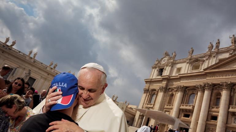 Pope Francis embraces a member of the crowd during a General Audience               Dave Yoder  National Geographic