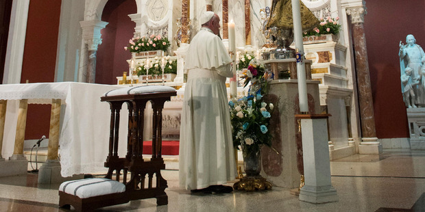 Pope Francis prays inside the sanctuary of the Virgin of Charity of Cobre in El Cobre Cuba