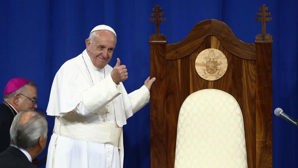 Pope Francis gestures to inmates next to a wooden chair made for him by inmates during his visit to Curran Fromhold Correctional Facility in Philadelphia Sunday Sept. 27 2015