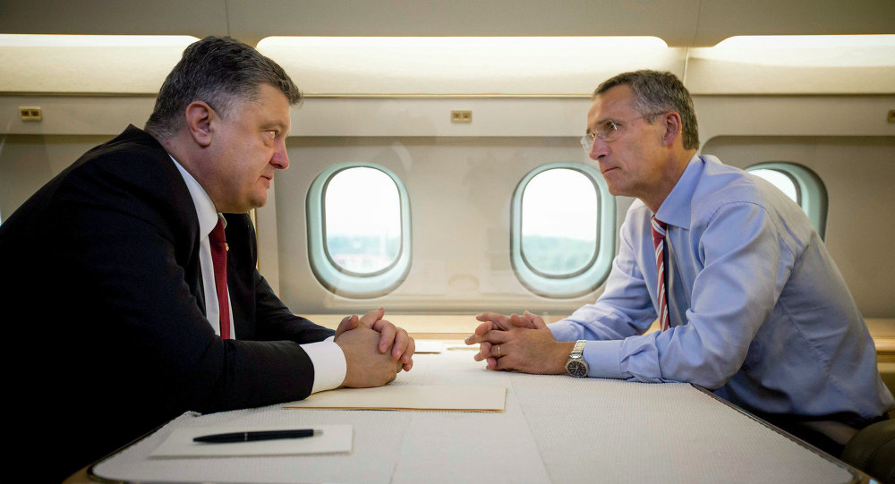 Ukrainian President Petro Poroshenko left and NATO Secretary General Jens Stoltenberg talk in a helicopter on the way to a military training ground outside Lviv western Ukraine Monday Sept. 21 2015