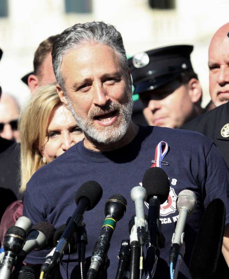 Comedian Jon Stewart stands with New York City first responders and speaks during a rally on Capitol Hill in Washington Wednesday