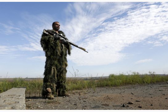 A Ukrainian sniper holds the position of Ukrainian forces on the front line in the Lugansk region on Thursday Aug. 27