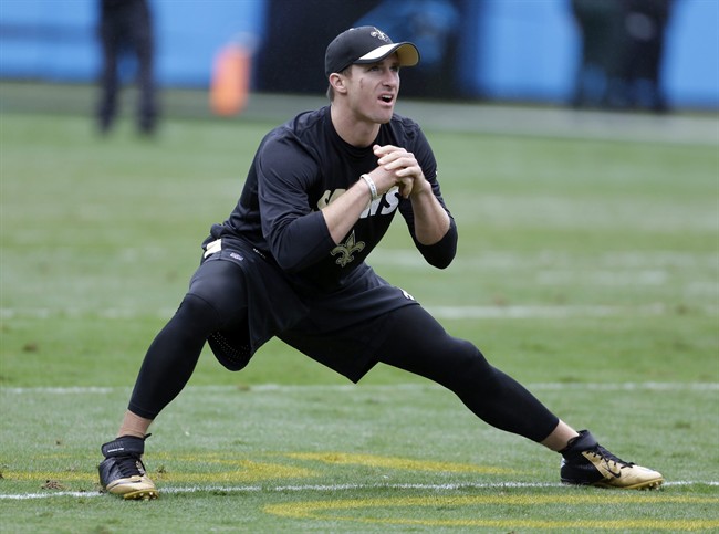 New Orleans Saints Drew Brees stretches before an NFL football game against the Carolina Panthers in Charlotte N.C. Sunday Sept. 27 2015. Brees was not starting the game