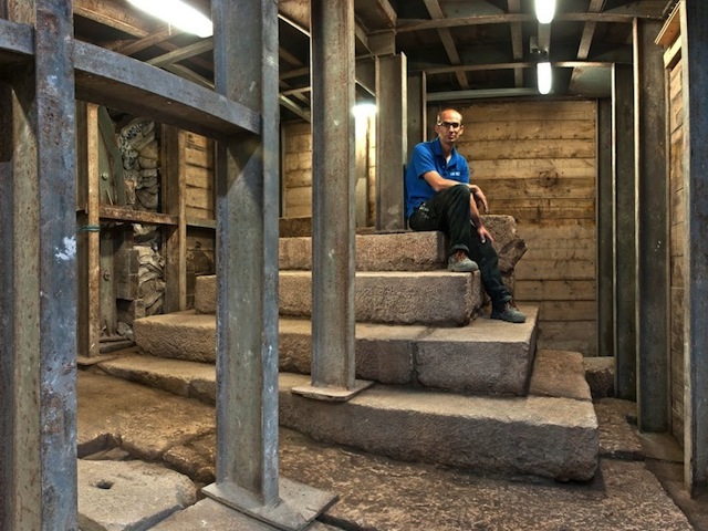 Dr. Joe Uziel of the Israel Antiquities Authority who co-directed the excavation offered perspective on the size by sitting atop the 2,000-year-old find that may have once served as a podium