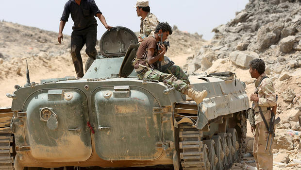 Soldiers loyal to Yemen's government ride on an armored vehicle in the frontline province of Marib