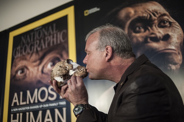 Professor Lee Berger kisses the skull of Homo Naledi a newly discovered human ancestor during the unveiling of the discovery