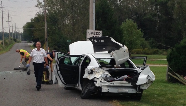 This Dodge Avenger collided with a school bus on Friday Sept. 18 after a mother reportedly jumped from the car after seeing a spider