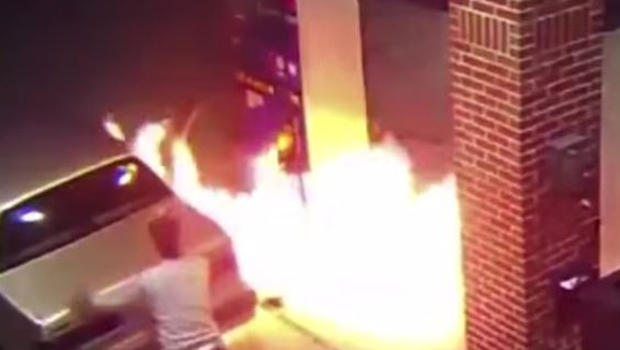 Still from a video claiming to show a man who set a gas station pump on fire near Detroit after he saw a spider on his car