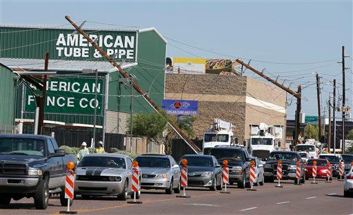 Power crews begin working on downed power lines early on Tuesday Sept. 1 2015 in Phoenix after monsoon storms hit the Phoenix area Monday night knocking out power to thousands delaying air travel and stranding motorists in flash floods. The storms