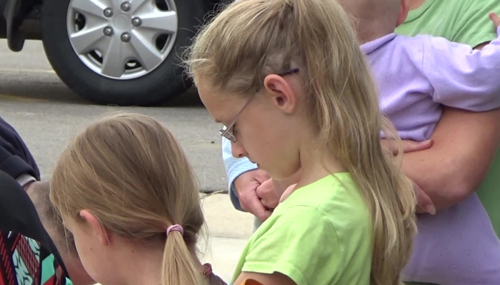 Students gathered Wednesday morning at a local flag pole to pray for their school