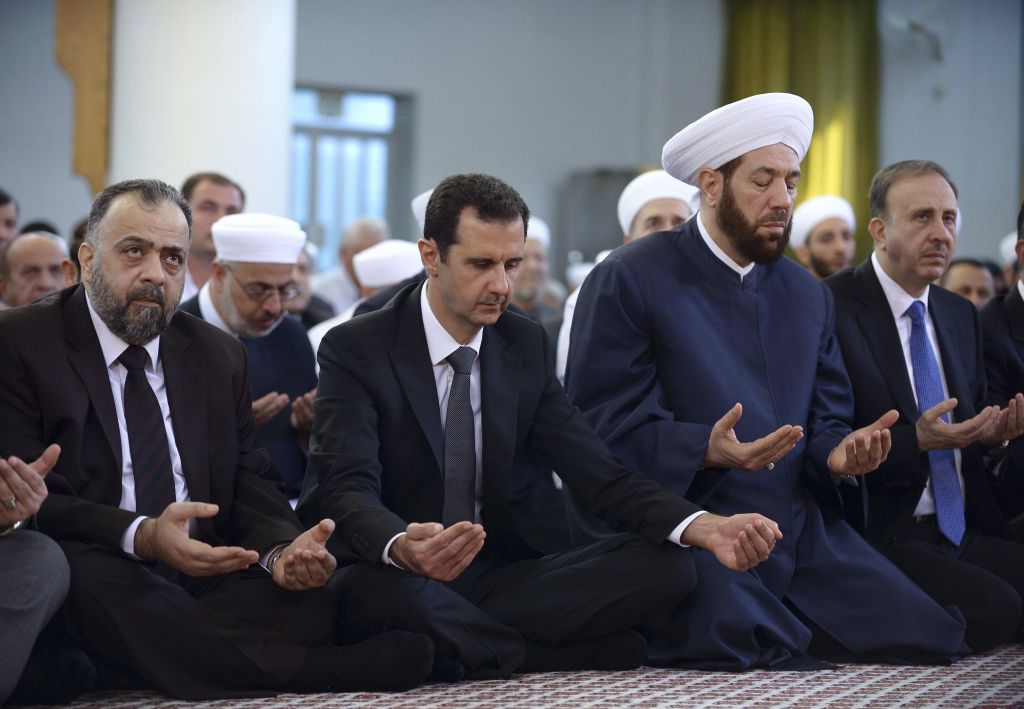 Syrian President Bashar Assad center prays during Eid al Adha prayers at a mosque in Damascus Syria