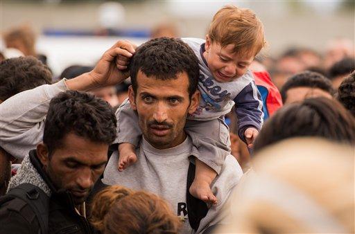 Syrian refugees arrive aboard a dinghy after crossing from Turkey to the island of Lesbos Greece. Friday Sept. 18 2015. More than 250,000 people have reached Greece clandestinely so far this year the vast majority of them Syrians or Afghans fleeing