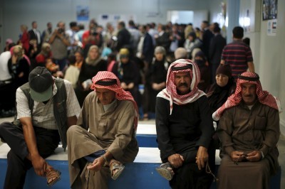 Syrian refugees wait to receive treatment at a health center in Jordan