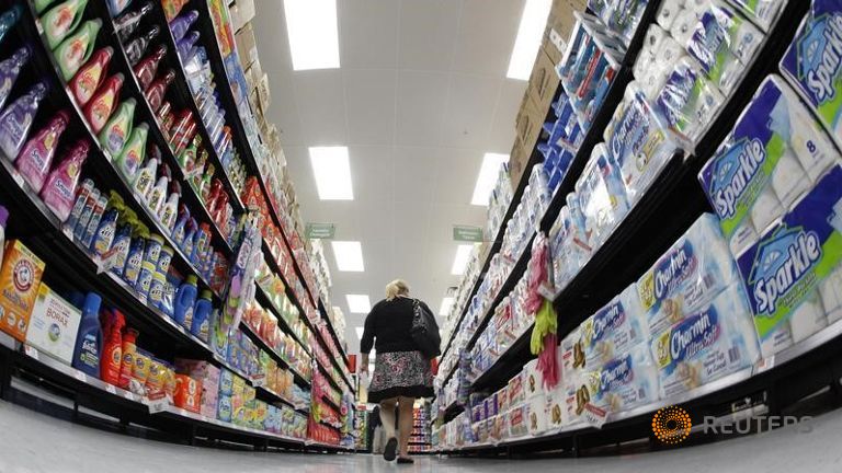 A shopper walks down an aisle in a newly opened Walmart Neighborhood Market in Chicago in this