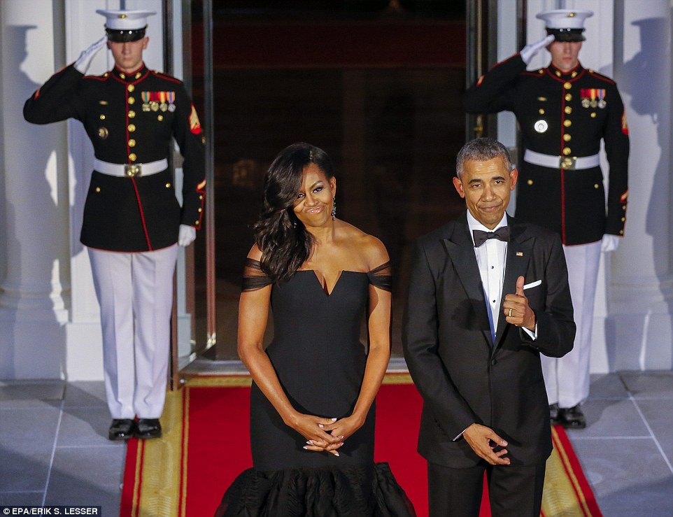 Dazzling First Lady Michelle Obama- who wore a $2,300 dress to meet the Pope this week- diplomatically opted for a black off-the-shoulder mermaid gown created by Chinese American designer Vera Wang